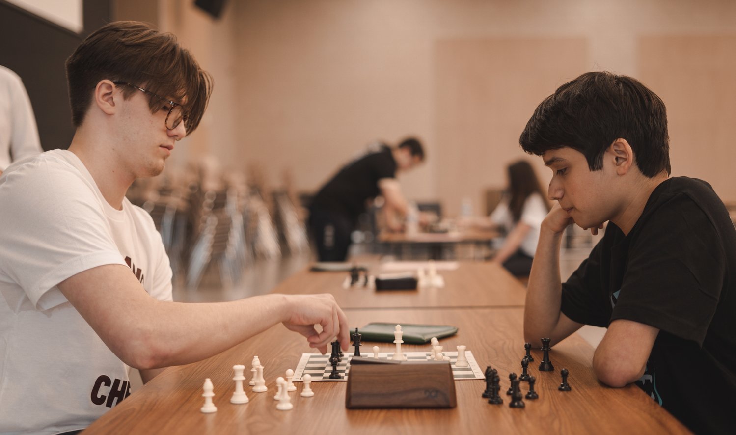 Two chess players consider their possible moves during a Feb. 25 match at Paetow High.